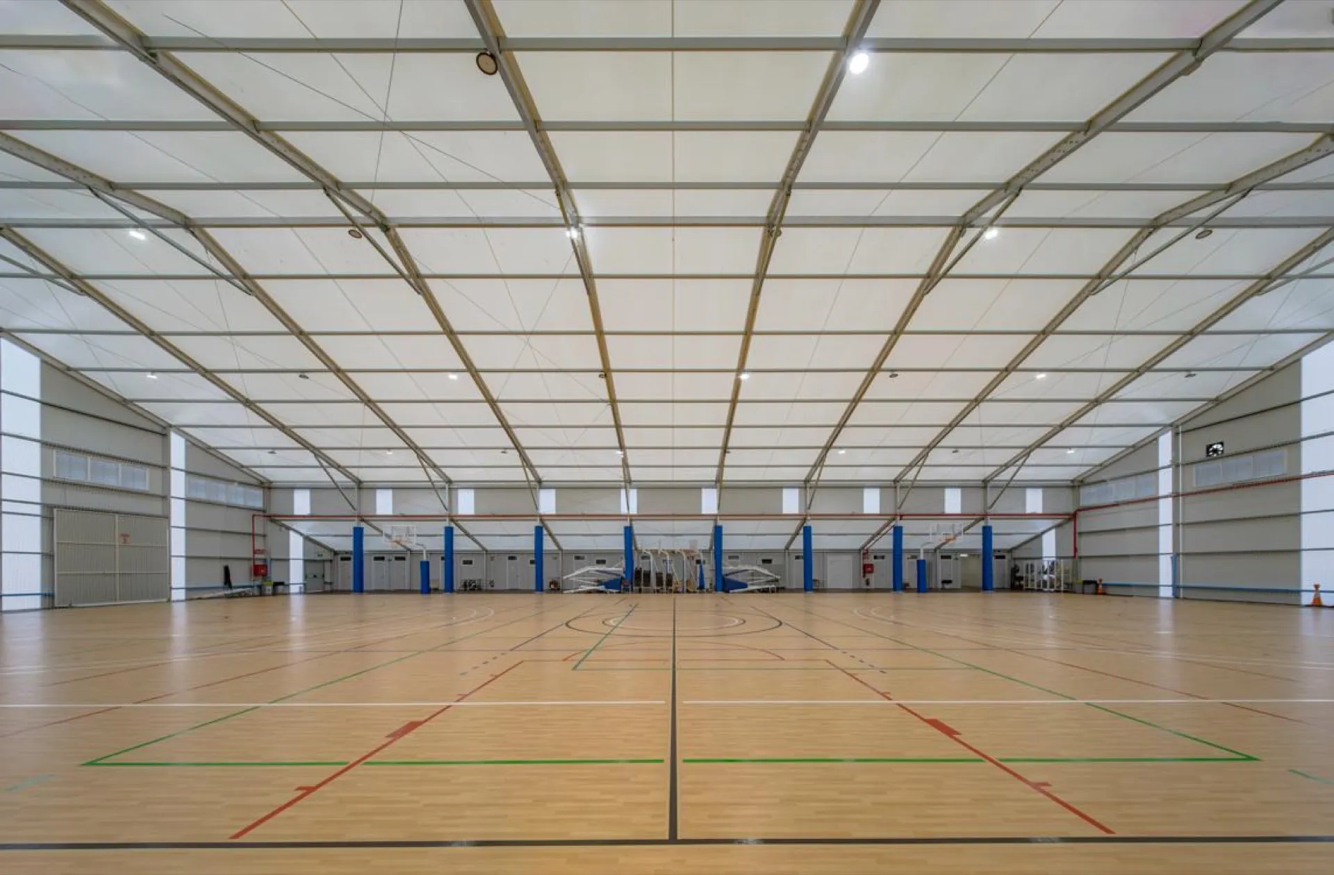 Interior amplio de pabellón deportivo desmontable con cancha de parquet